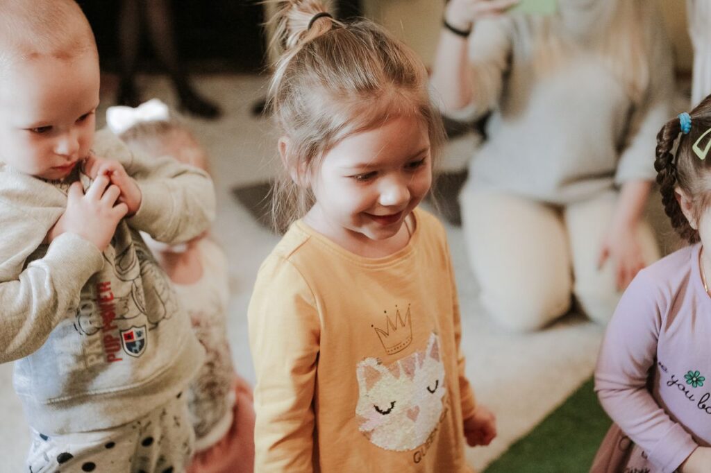 The Art of Drawing Readers In: Your attractive post title goes here Happy children playing indoors with toys, showcasing joyful interaction and smiles.